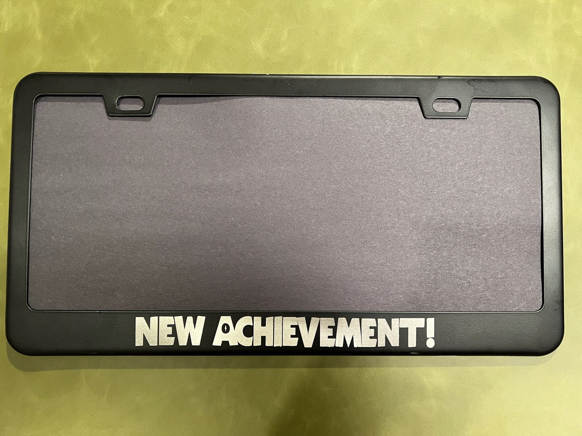 New Achievement license plate frame