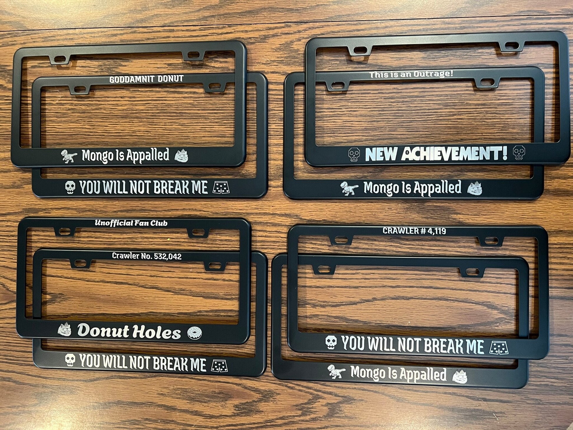 Four DCC license plate frame designs